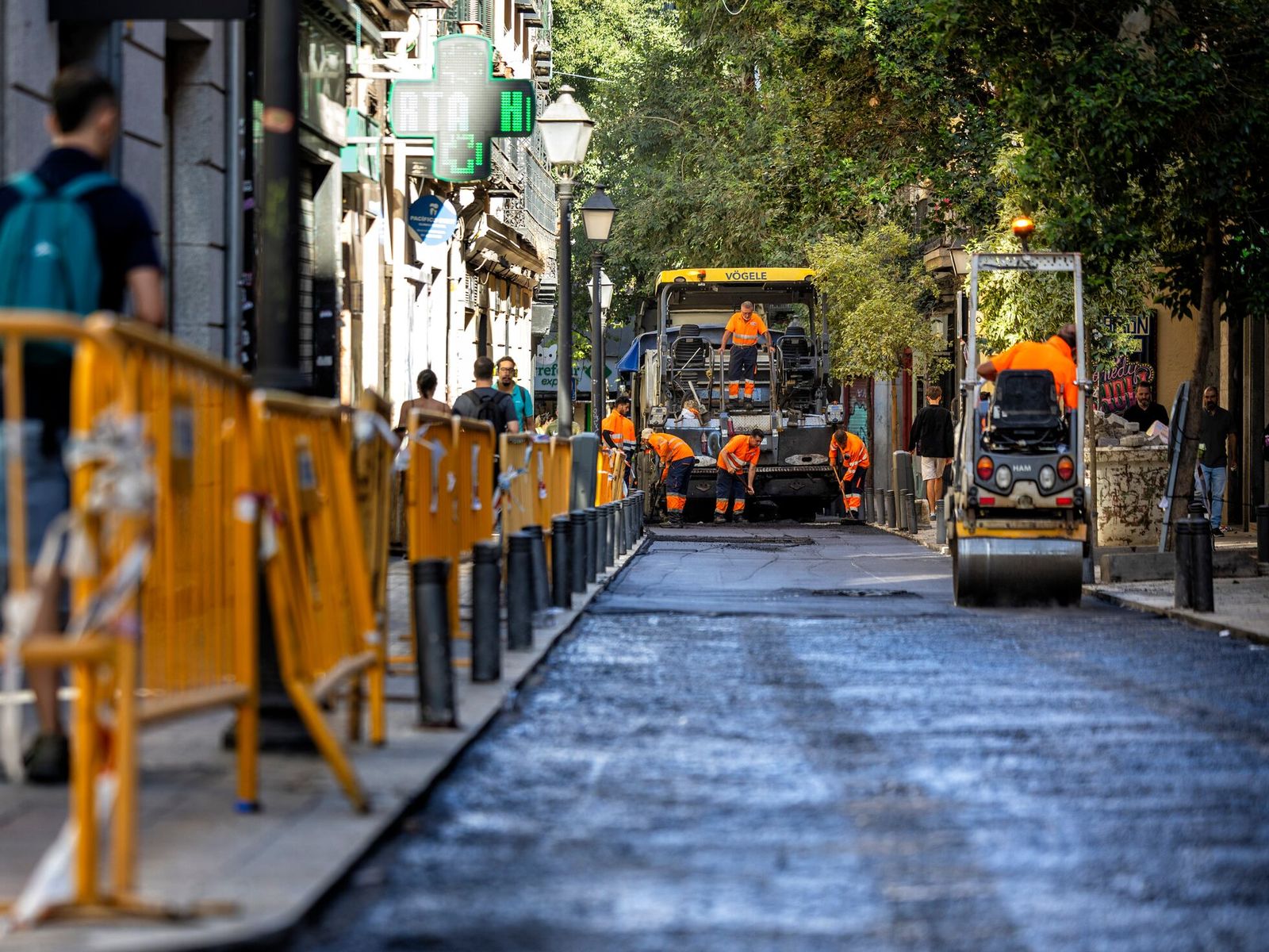 Màquines asfaltant un carrer durant una obra d'urbanització